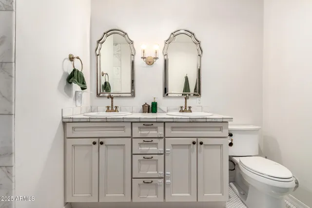 a bathroom with 2 sink and a toilet