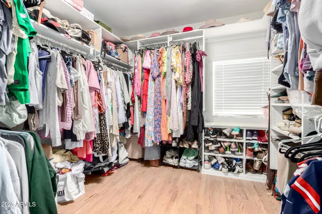 a view of walk in closet with clothes