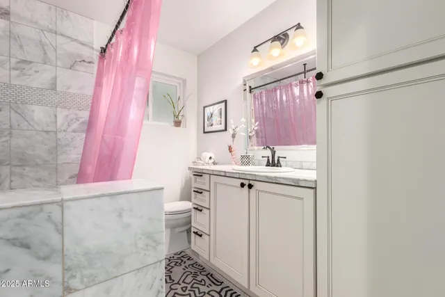 a bathroom with a sink a vanity and a mirror
