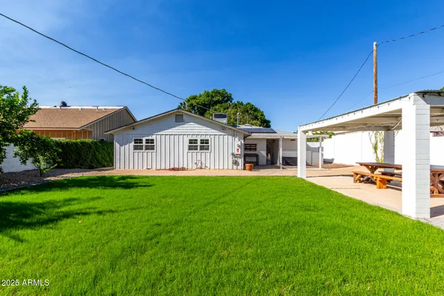 a view of a house with backyard and porch