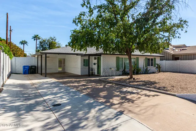 a view of a house with a yard and a garage