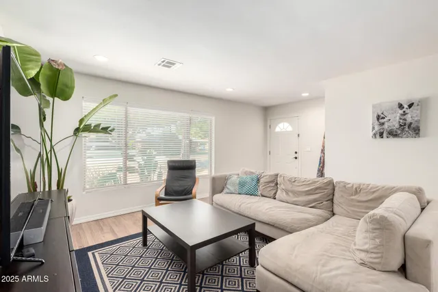 a living room with furniture and a large window