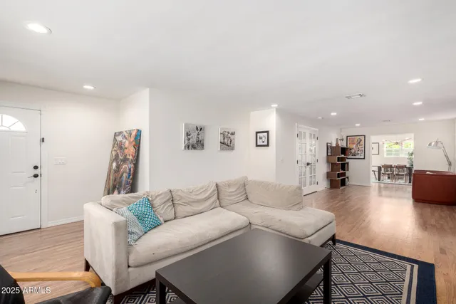 a living room with furniture and a wooden floor