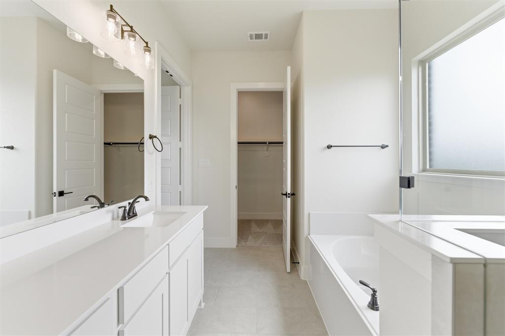 2433 Meteor Drive Krum, TX 76249 - Photo 19 of 29 Dual vanity with white cabinetry and countertops