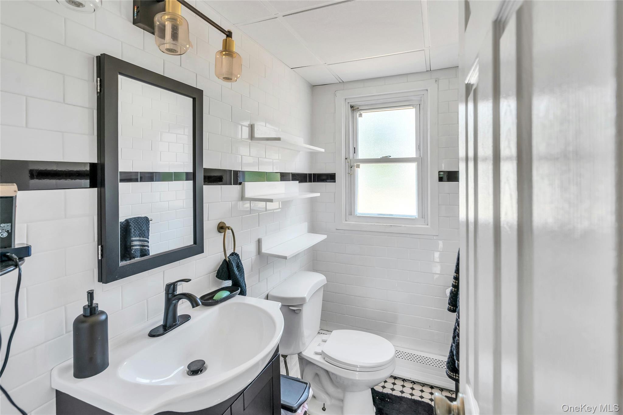 639 Townline Road Hauppauge, NY 11788 - Photo 14 of 28 a bathroom with a toilet sink and mirror