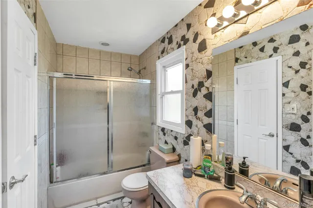 a bedroom with a bed a flat screen tv and dresser