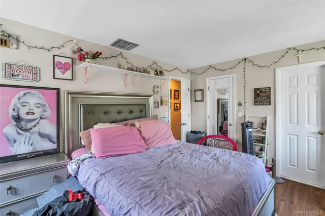 a bedroom with furniture and a flat screen tv