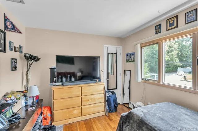 a bedroom with a bed and dresser