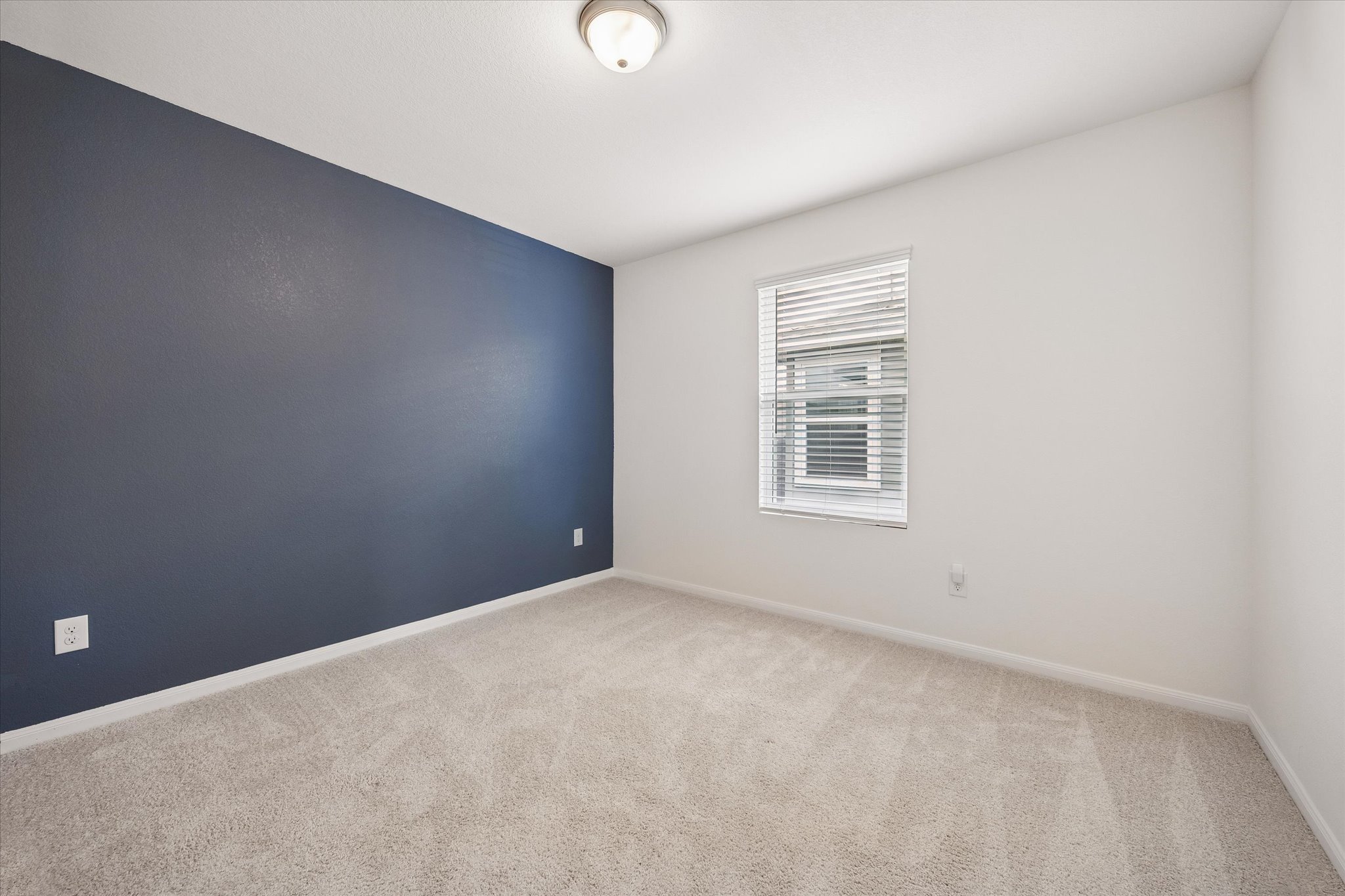 157 LT Rusty Drive Jarrell, TX 76537 - Photo 27 of 39 Spare room featuring light colored carpet and an accent wall