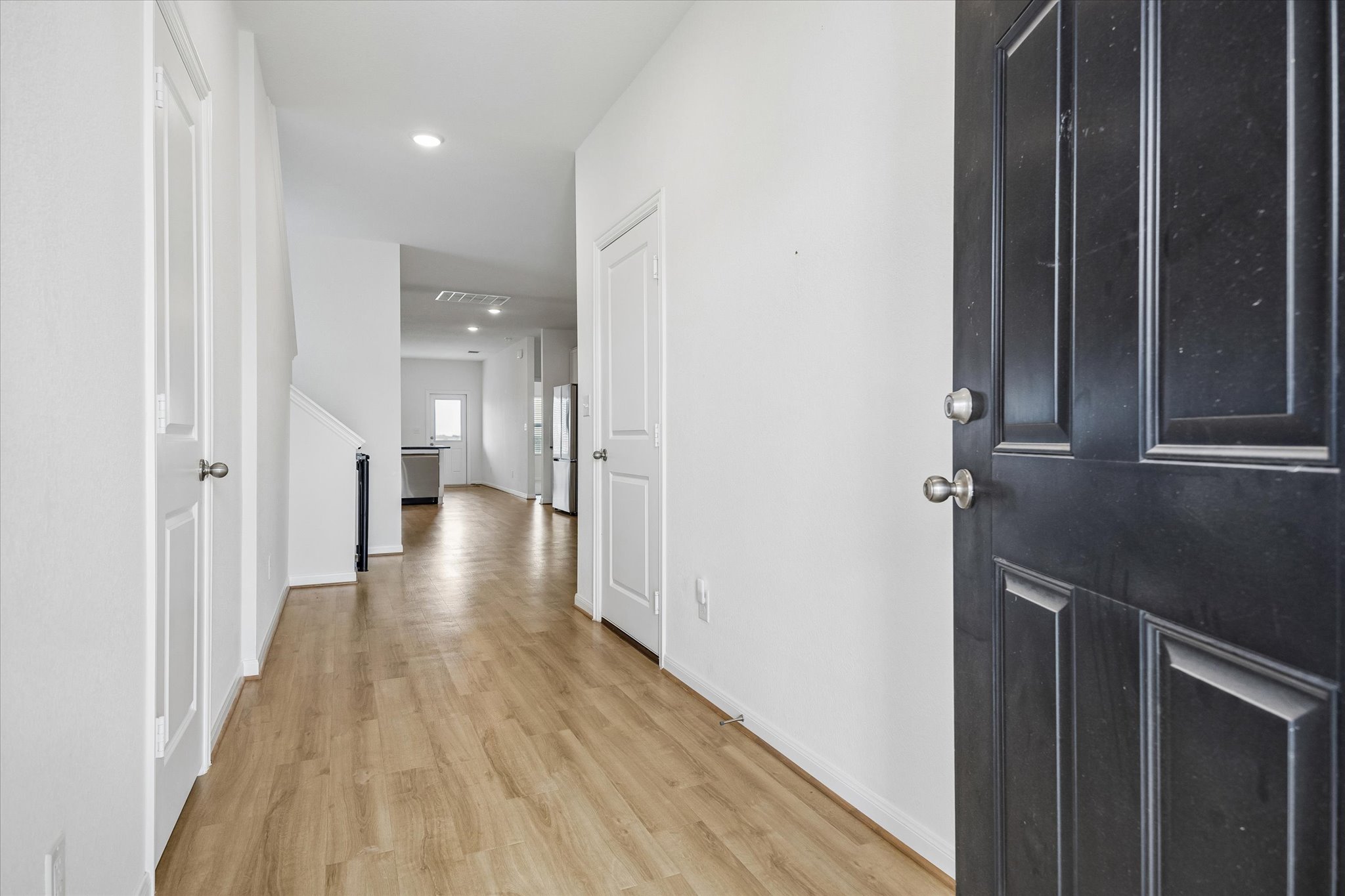 157 LT Rusty Drive Jarrell, TX 76537 - Photo 3 of 39 Hallway featuring light wood-style floors and recessed lighting