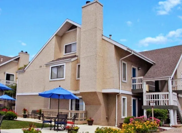 a front view of a building with umbrellas