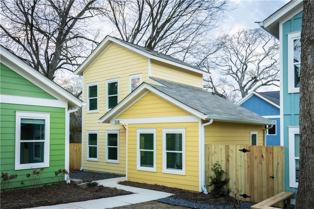 1351 Finley Street Northeast, Unit B Atlanta, GA 30307 - Photo 1 of 1 a view of a brick house with large windows and a large tree