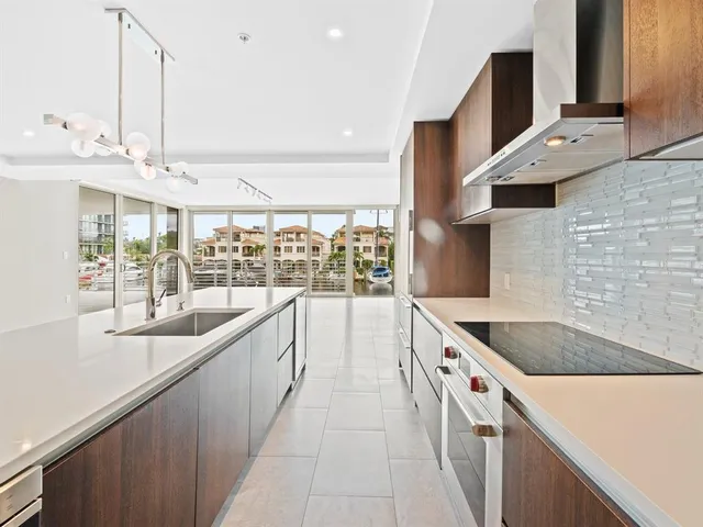 a kitchen with stainless steel appliances granite countertop a sink and a wooden floors