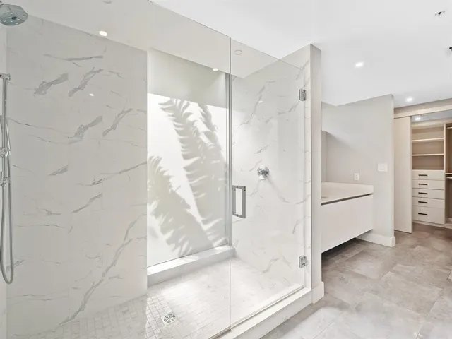 a bathroom with a glass shower door and a bathtub