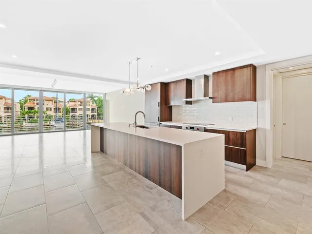 a large white kitchen with a large window