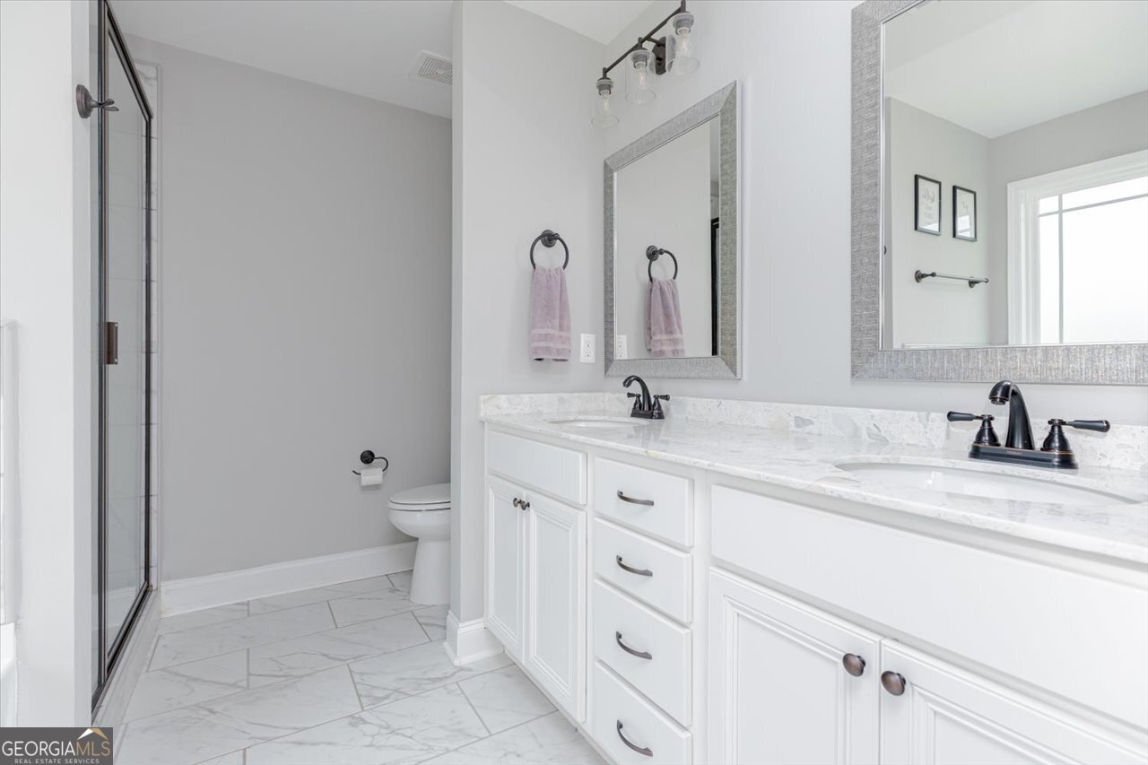 104 Meredith Layne Court Perry, GA 31069 - Photo 25 of 46 a bathroom with a sink a toilet and a mirror