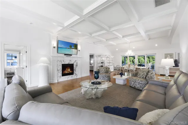 a living room with furniture fireplace and a large window