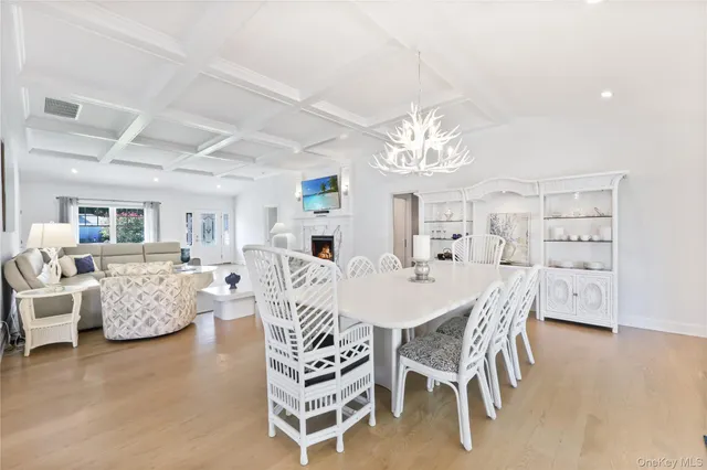a view of a dining room with furniture and chandelier