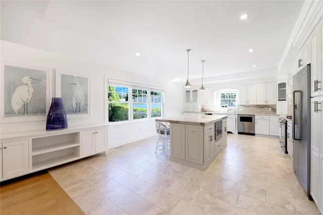 a large white kitchen with white cabinets and a stove