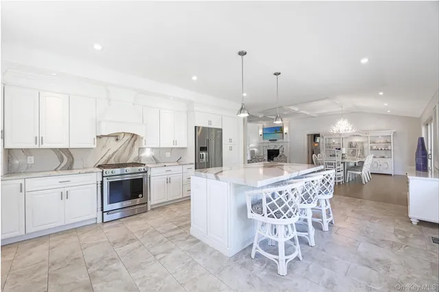 a kitchen with appliances a sink and cabinets