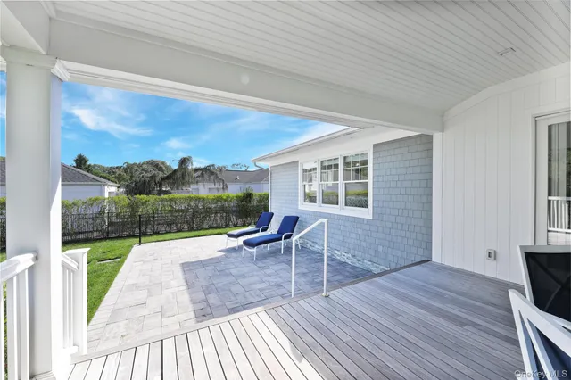 a view of house with yard and wooden floor