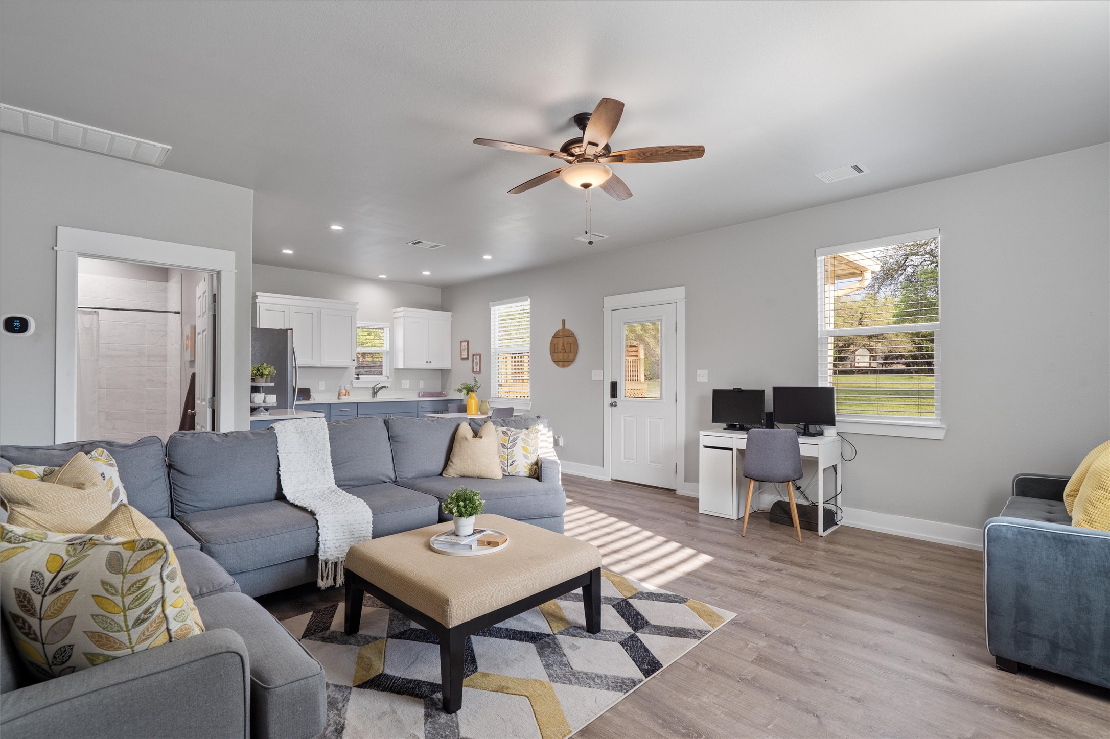 13105 Rooster Springs Road Austin, TX 78737 - Photo 28 of 38 This inviting living area features light-colored walls, wood-look flooring, and a ceiling fan