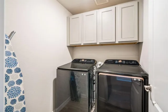 a view of washer and dryer with kitchen countertops