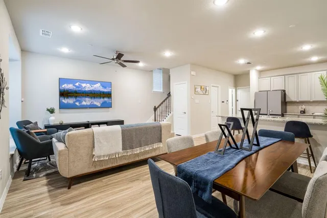 a living room with furniture and kitchen view