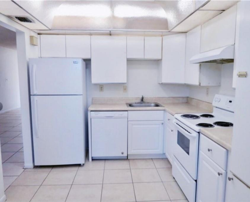 8401 West Sample Road, Unit 21 Coral Springs, FL 33065 - Photo 2 of 6 a kitchen with cabinets appliances and a sink