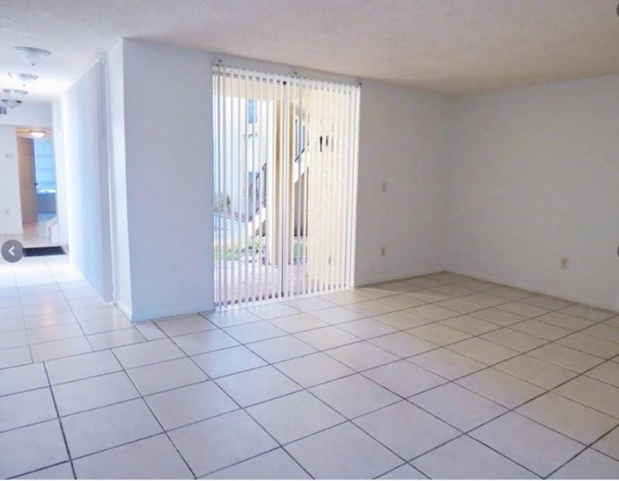 8401 West Sample Road, Unit 21 Coral Springs, FL 33065 - Photo 3 of 6 a view of an empty room and window