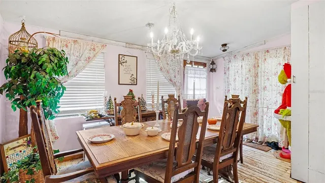 a view of a dining room with furniture and chandelier