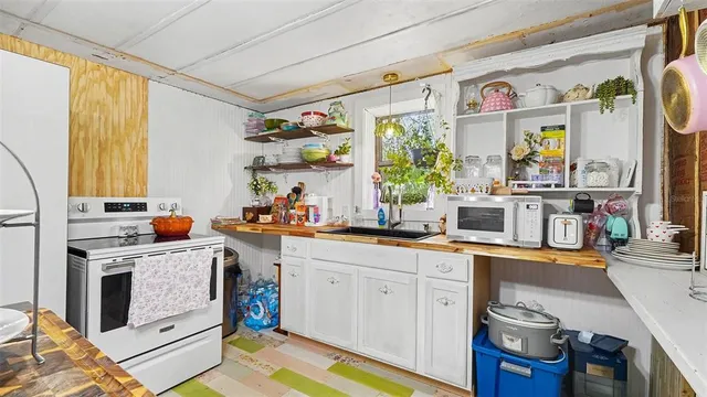 a kitchen with stainless steel appliances a stove a sink and a refrigerator