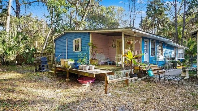 a view of backyard of house with outdoor seating