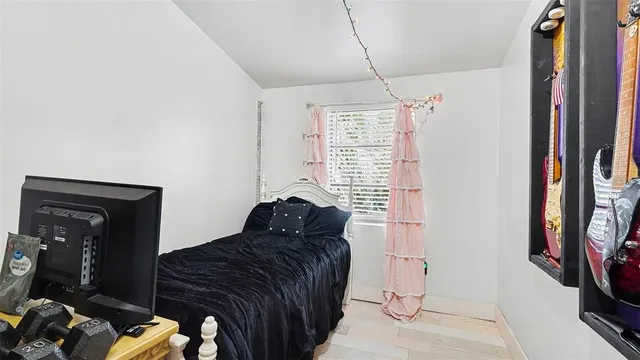 a bedroom with a bed and a flat tv screen