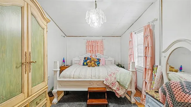 a bedroom with furniture and a chandelier