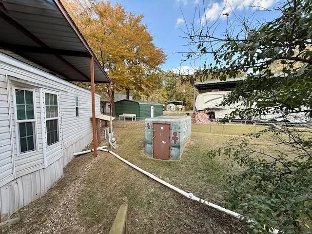 a view of a backyard with table and chairs