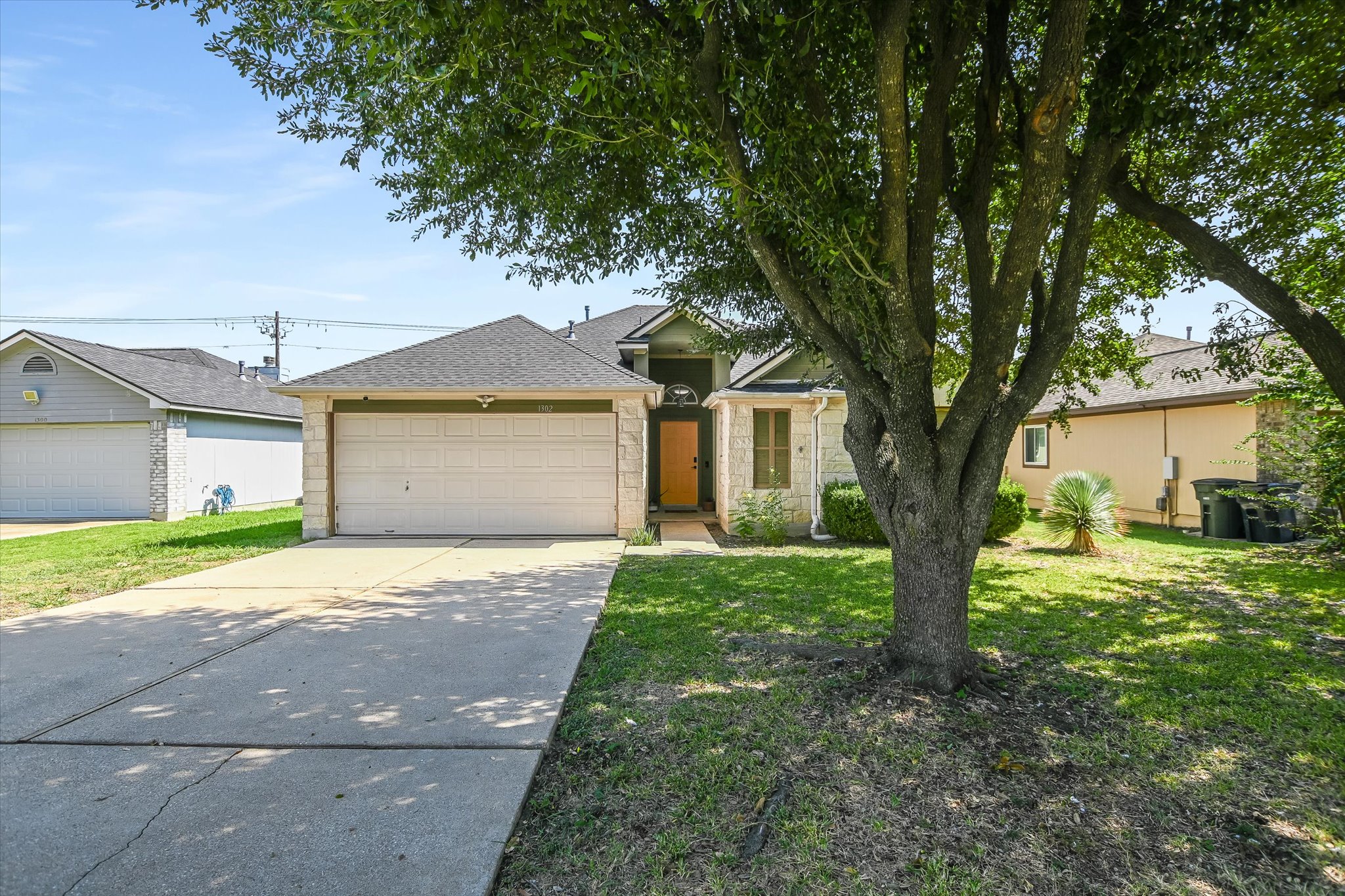 1302 Redbud Lane Leander, TX 78641 - Photo 23 of 28 a front view of a house with a yard and garage