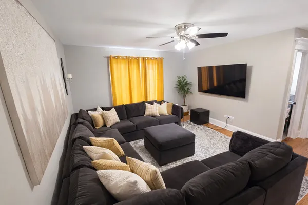a bedroom with a bed couch and a flat screen tv