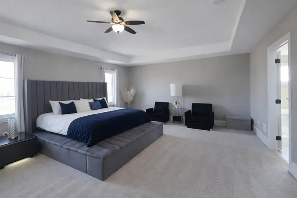 a spacious bathroom with a double vanity sink a toilet and a mirror