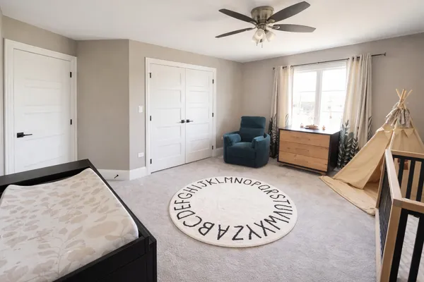 a bedroom with a bed a flat screen tv and a couch