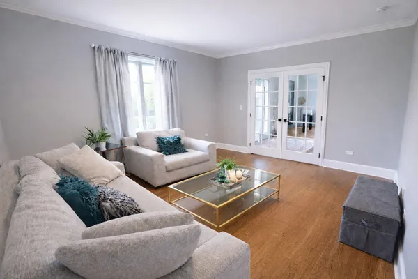 a living room with furniture and wooden floor