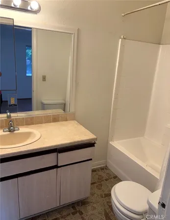 a bathroom with a sink a toilet and bathtub