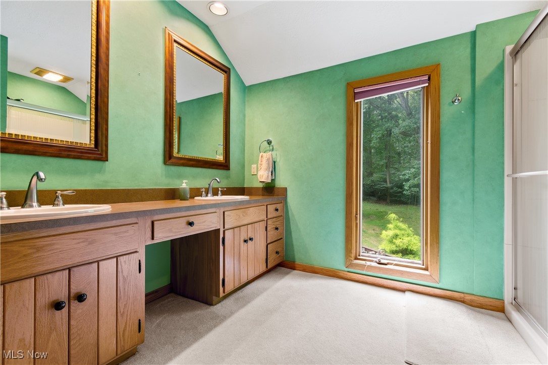 7098 Taylor Road Clinton, OH 44216 - Photo 26 of 39 Bathroom featuring double vanity and vaulted ceiling