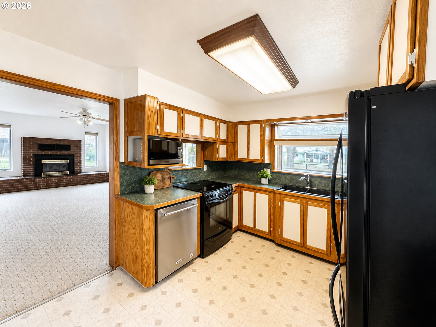 1920 Cliff Street Baker City, OR 97814 - Photo 12 of 34 a kitchen with stainless steel appliances granite countertop a stove and a refrigerator