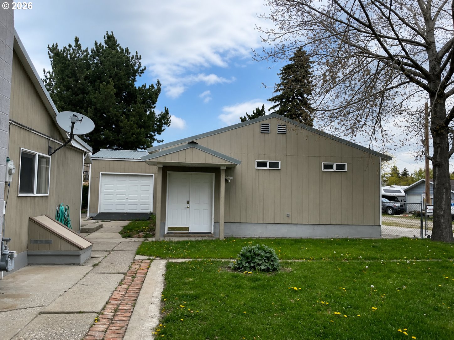 1920 Cliff Street Baker City, OR 97814 - Photo 26 of 34 a front view of house with yard and trees in the background