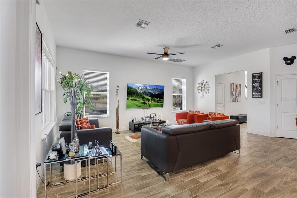 15807 Sweet Lemon Way Winter Garden, FL 34787 - Photo 11 of 35 a living room with furniture and a flat screen tv