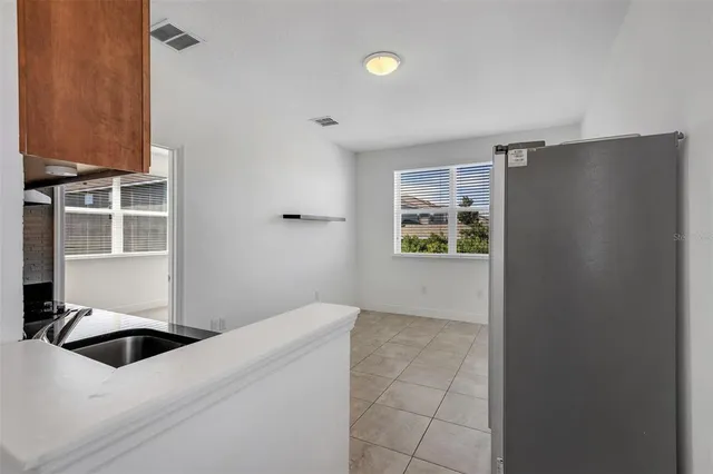 a kitchen with stainless steel appliances a refrigerator and a stove top oven