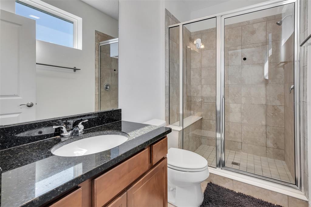 15807 Sweet Lemon Way Winter Garden, FL 34787 - Photo 21 of 35 a bathroom with a granite countertop sink toilet and shower