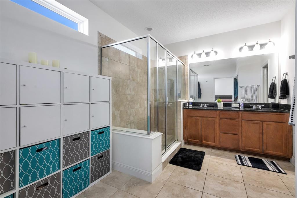 15807 Sweet Lemon Way Winter Garden, FL 34787 - Photo 24 of 35 a bathroom with a sink a mirror and a shower