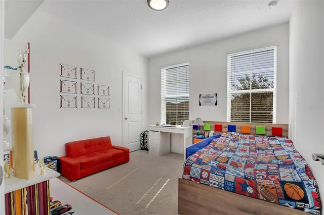 a bedroom with bed and window